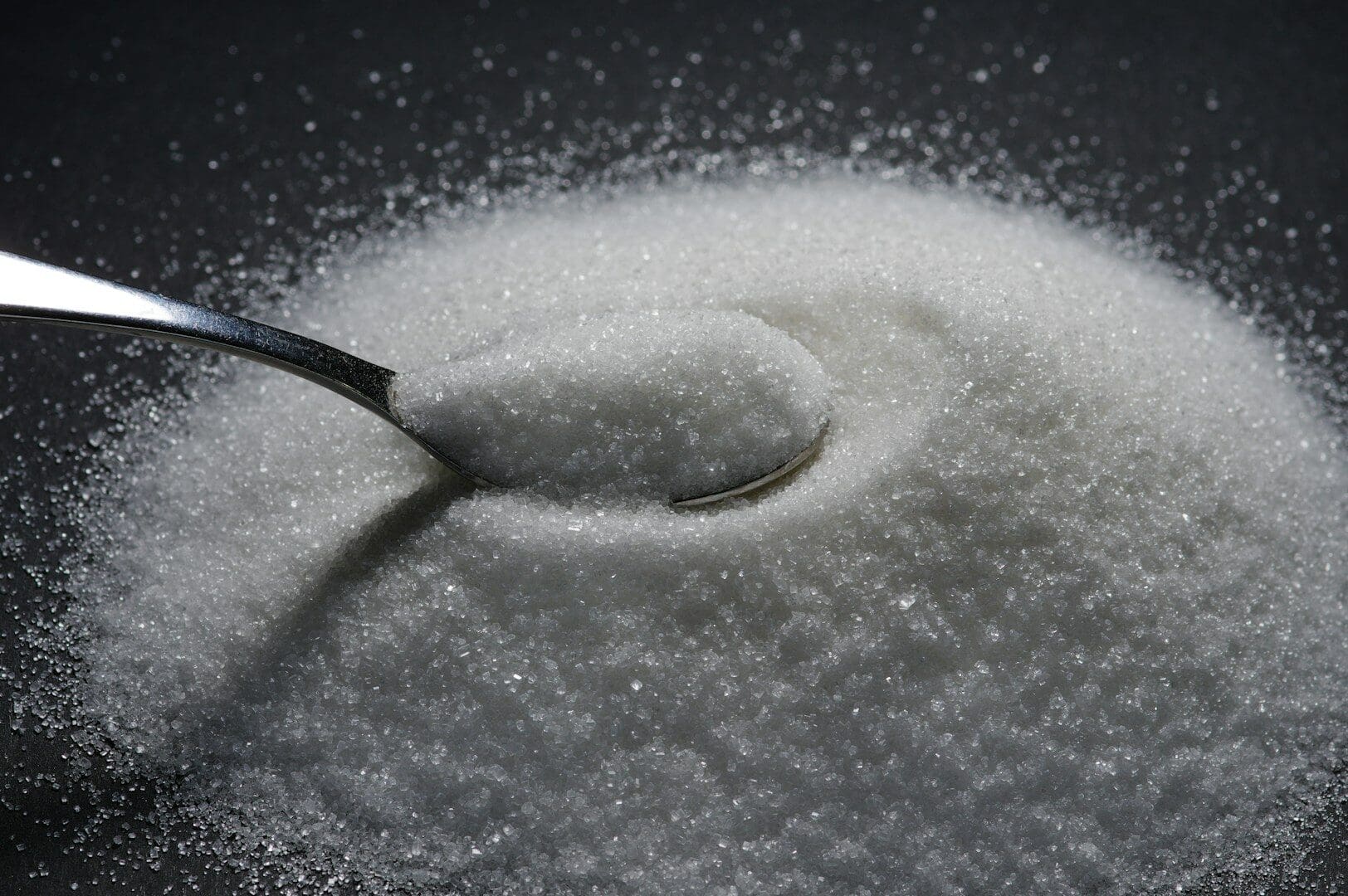 a spoon full of sugar on top of a table